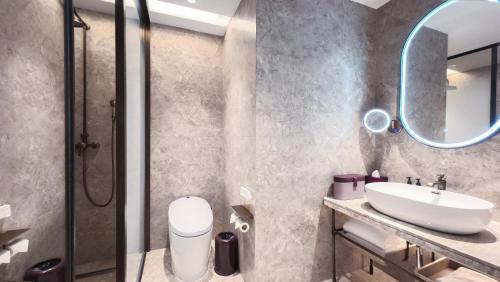 a bathroom with a sink and a mirror at Mercure Beijing Downtown in Beijing