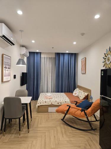 a bedroom with two beds and a table and chairs at Happy Home S112 in Gia Lâm Pho