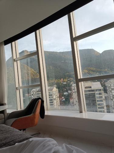 a bedroom with a view of a city from a window at Hotel Nacional Rio in Rio de Janeiro