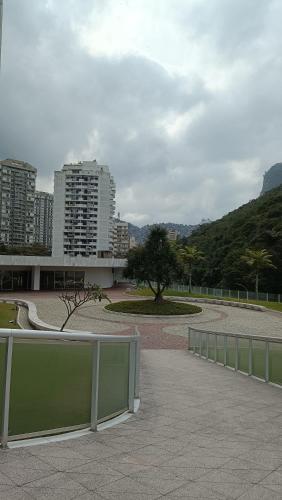 a park with a fence and a tree and buildings at Hotel Nacional Rio in Rio de Janeiro
