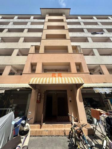 a tall building with bikes parked in front of it at Budget 1b1b Heart of Ramkamheng in Sathani Khlong Tan