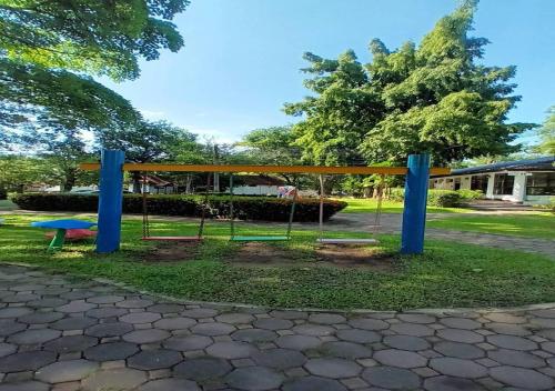 a park with a swing set in the grass at Supalai Pasak Resort Hotel And Spa in Kaeng Khoi