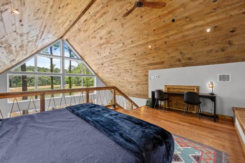 a bedroom with a bed and a wooden ceiling at LostForest Cabins in Richards