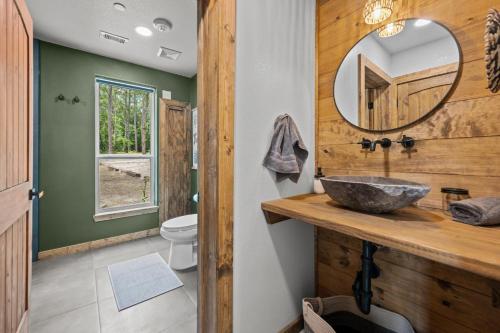 a bathroom with a sink and a mirror at LostForest Cabins in Richards