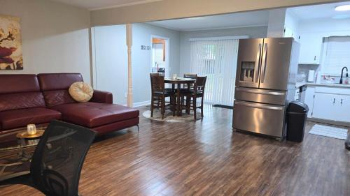 a living room with a couch and a kitchen at Irie Villa GameRoom Kids&PetFriendly CharcoalGrill in Fayetteville