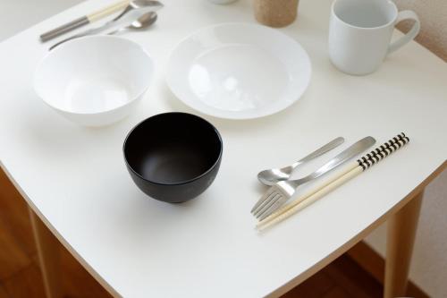 a table with plates and utensils on it at G62 駅徒歩3分 おしゃれで可愛い 4人可能 3 minutes walk from the station Nagoya駅から1駅 in Nagoya