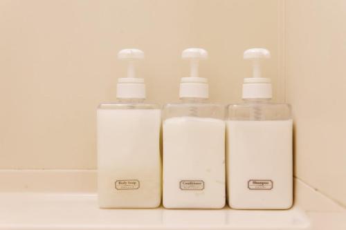 a group of three soap dispensers in a bathroom at G62 駅徒歩3分 おしゃれで可愛い 4人可能 3 minutes walk from the station Nagoya駅から1駅 in Nagoya