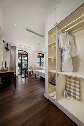 a room with a living room with a couch and a table at Jade Boutique Hotel in Hanoi