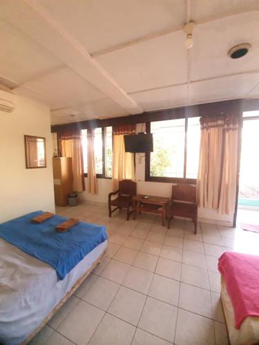 a bedroom with a bed and a table with a tv at Ki Agung Prestise Hotel in Timuran