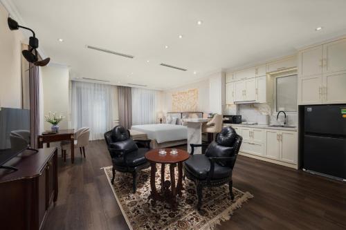 a living room with a kitchen and a dining room at Jade Boutique Hotel in Hanoi