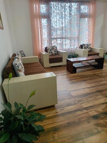 a living room with two couches and a table at Mawdong Homestay in Shillong