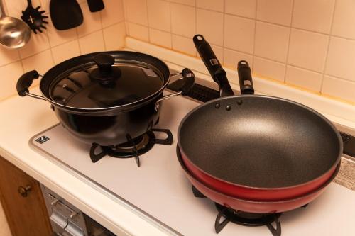 a pan on a stove with a pot on it at Ise Shima Moritoumi in Shima