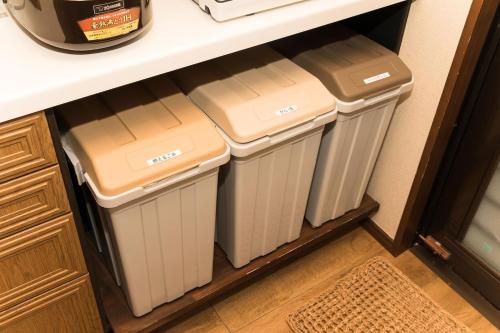three trash cans in a kitchen under a counter at Ise Shima Moritoumi in Shima