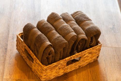 a basket filled with rolled towels on a wooden floor at Ise Shima Moritoumi in Shima