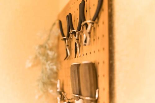 a bunch of utensils hanging on a wall at Ise Shima Moritoumi in Shima