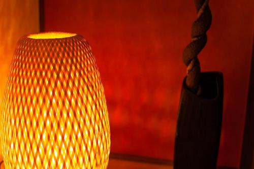 a close up of a vase with a red background at Ise Shima Moritoumi in Shima