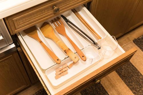 a drawer filled with wooden utensils on a table at Ise Shima Moritoumi in Shima