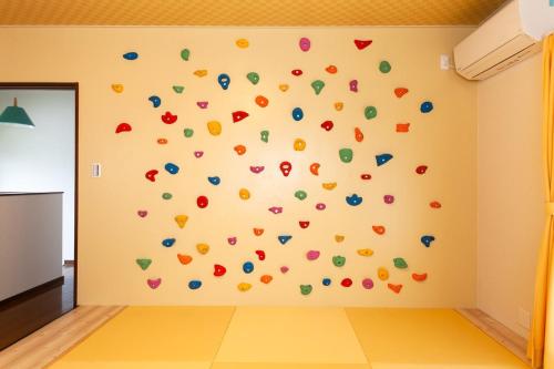 a room with a wall with colorful confetti on it at Ise Shima Moritoumi in Shima
