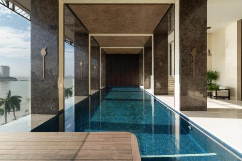 an infinity pool in the middle of a house with a view at SOMA HOTEL Riverside in Phnom Penh