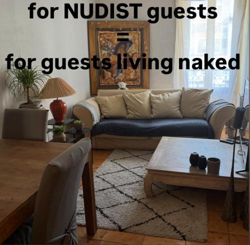 a living room with a couch and a coffee table at Room for NUDISTS near Nice port in a shared apartment in Nice