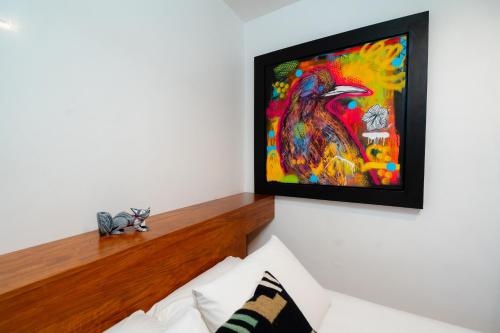 a living room with a painting on the wall at Casa de Arte Hotel Boutique in Oaxaca City