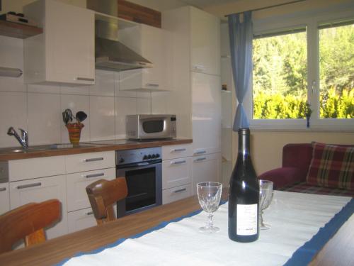 a bottle of wine sitting on a table in a kitchen at Apart Raphael in Niederthai