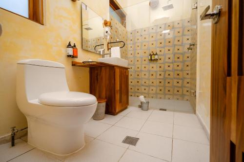 a bathroom with a toilet and a sink and a shower at Casa de Arte Hotel Boutique in Oaxaca City