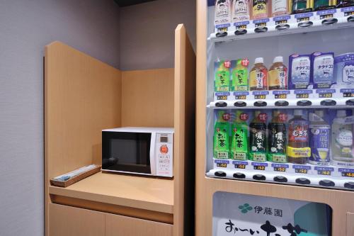 a vending machine with a microwave in a room at Onyado Nono Toyama Natural Hot Spring in Toyama
