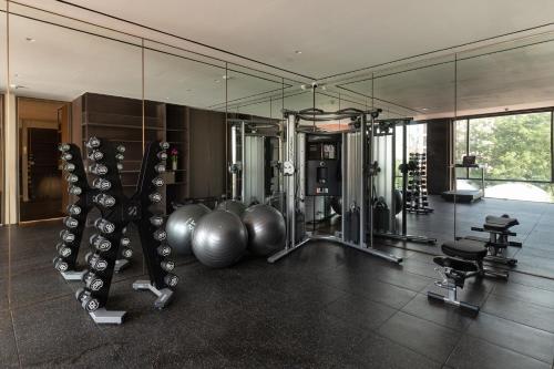 a gym with several exercise equipment in a room at SOMA HOTEL Riverside in Phnom Penh