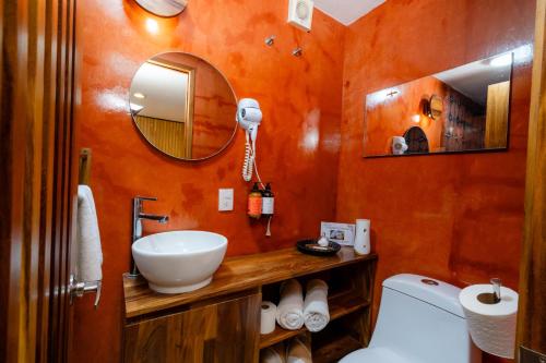 a bathroom with a sink and a mirror at Casa de Arte Hotel Boutique in Oaxaca City