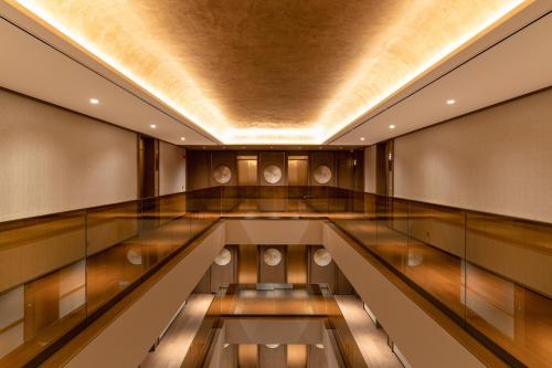 an empty corridor in a building with a ceiling at SOMA HOTEL Riverside in Phnom Penh
