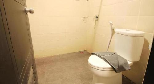 a small bathroom with a white toilet in a room at Sambi Resort, Spa & Resto in Yogyakarta