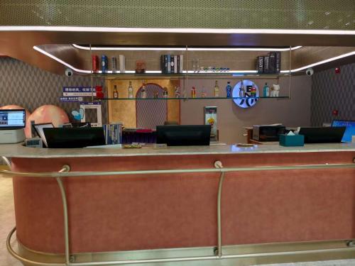 a bar in a restaurant with a counter at Orange Hotel Beijing Temple of Heaven North Gate in Beijing