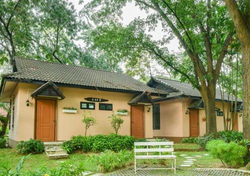a house with a bench in front of it at Supalai Pasak Resort Hotel And Spa in Kaeng Khoi