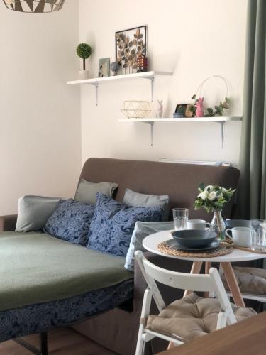 a living room with a couch and a table at Apartment Prague Airport- 5 minute drive from AirPort in Tuchoměřice