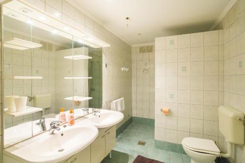 a bathroom with a sink and a toilet and a mirror at Central Apartment in Dubrovnik
