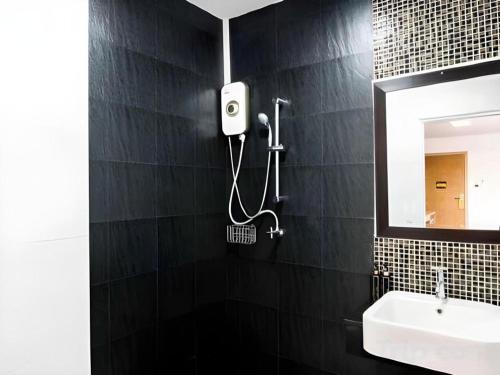 a bathroom with a sink and a mirror at The Circle Hotel in Buriram