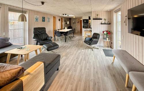 a living room with a couch and chairs and a table at Four-Bedroom Holiday Home In Haderslev in Diernæs