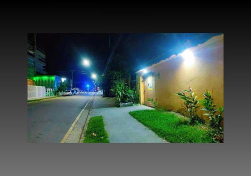 an empty street at night with lights on a building at Pousada Canto de Bertioga in Bertioga
