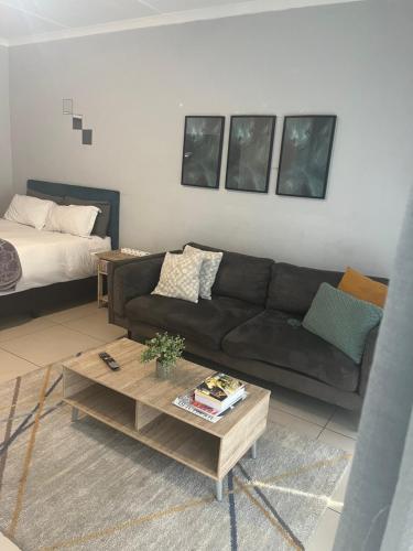a living room with a couch and a coffee table at Poppy Rentals in Fourways