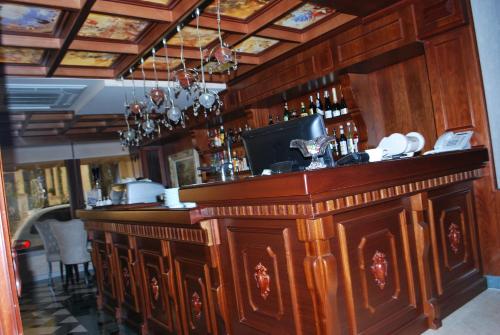 a bar in a restaurant with a wooden counter at Hotel Vila Sigal Korce in Korçë