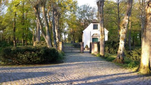 a cobblestone road in front of a white house at City Hotel in Delmenhorst