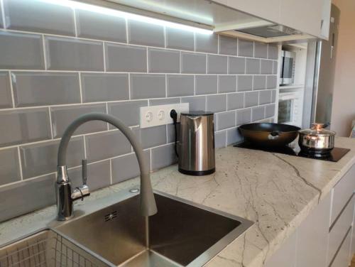 a kitchen with a sink and a counter top with a sink at Гостевой дом Алтын Булун - Golden Bay in Chok-Tal