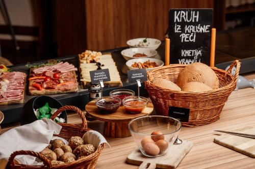 a table with baskets of food and other foods at Terme Banovci - Hotel Zeleni Gaj in Banovci