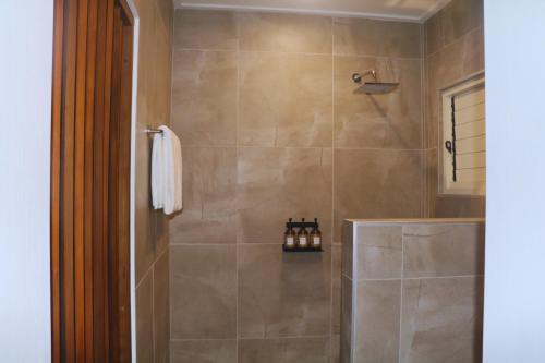a bathroom with a walk in shower with a shower at Nawi Island Marina Accommodation in Savusavu