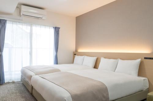 Postel nebo postele na pokoji v ubytování Regale Namba