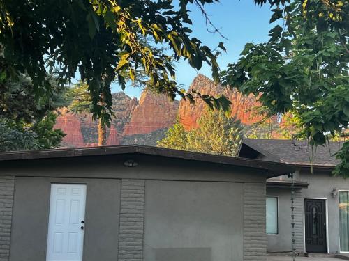a mural on the roof of a house with a garage at Sedona Uptown Gem!Large yard w grass and shade trees! Views!! NEW! BARREL SAUNA!!! Close to trails, walk to Uptown Sedona, restaurants and shopping in Sedona