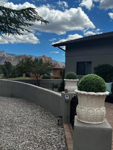 two white vases sitting next to a fence at Sedona Uptown Gem!Large yard w grass and shade trees! Views!! NEW! BARREL SAUNA!!! Close to trails, walk to Uptown Sedona, restaurants and shopping in Sedona