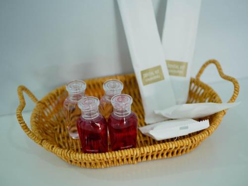 a basket filled with bottles of syrup and a remote control at Borrii House โบ ลี่ เฮาท์ in Layan Beach