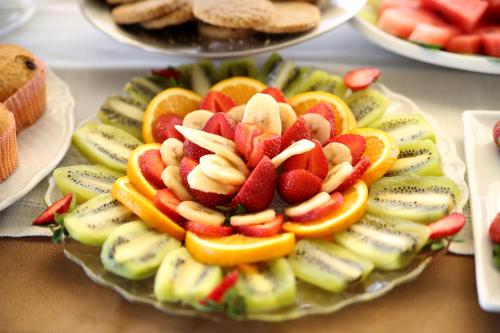 a bowl of fruit on a plate on a table at Oxford hotel in Tirana